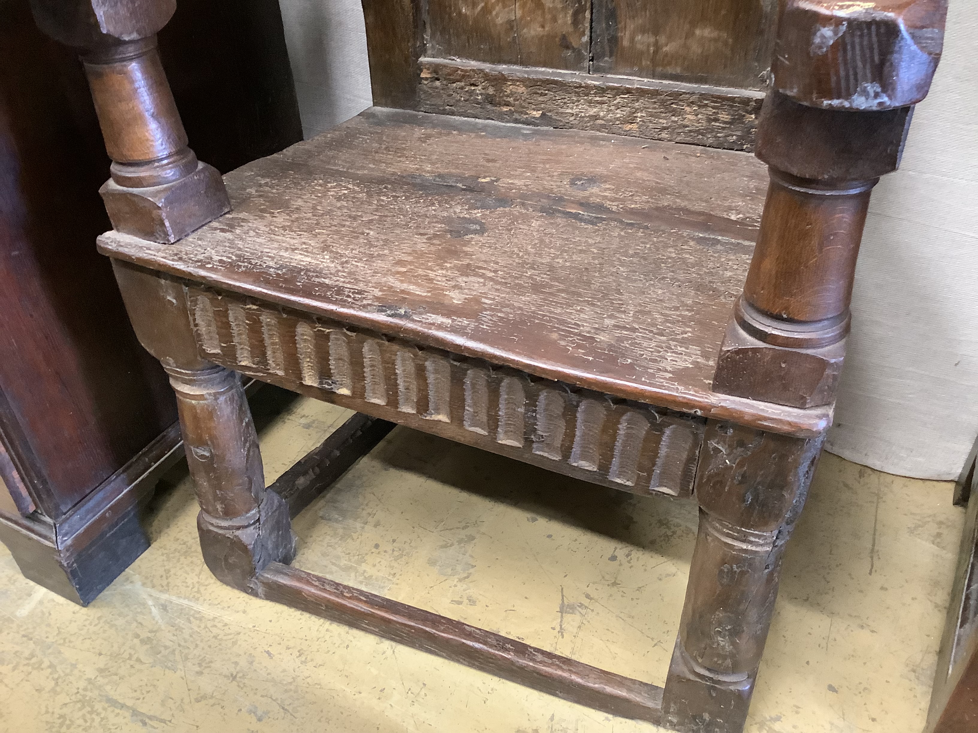 A 17th century oak panelled back armchair